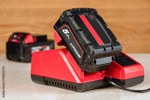 The process of charging a lithium battery from a cordless construction tool. The battery from the screwdriver is charged in the charger