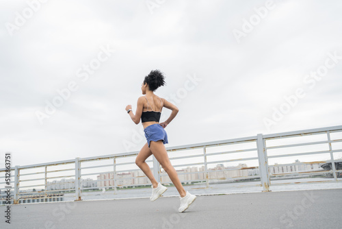 Female athlete runner runs in sportswear, active exercises for health