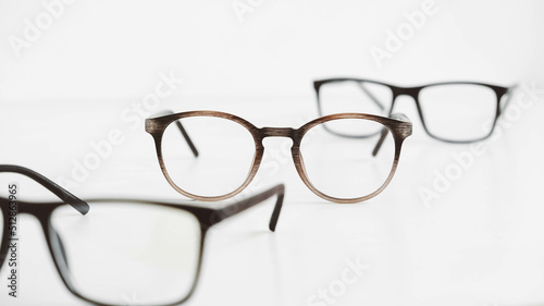 Three optical glasses of different shapes on a white background