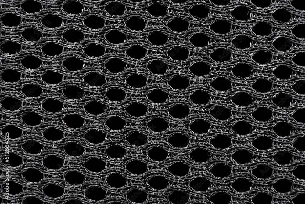 Texture of black material with mesh structure. Background from fabric in with small circles