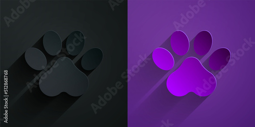 Paper cut Paw print icon isolated on black on purple background. Dog or cat paw print. Animal track. Paper art style. Vector