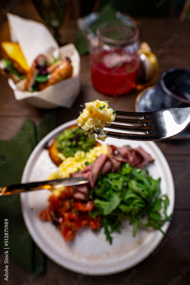 Egg in a hole of bread heart shape, microgreens, healthy food Breakfast, tea, black background