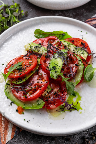 Sliced avocado with cream cheese and tomatoes on a plate. Selective focus, macro. Keto diet.