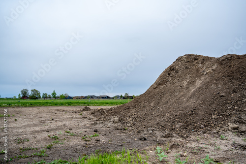 stockpiled topsoil at a residential development construction site. photo