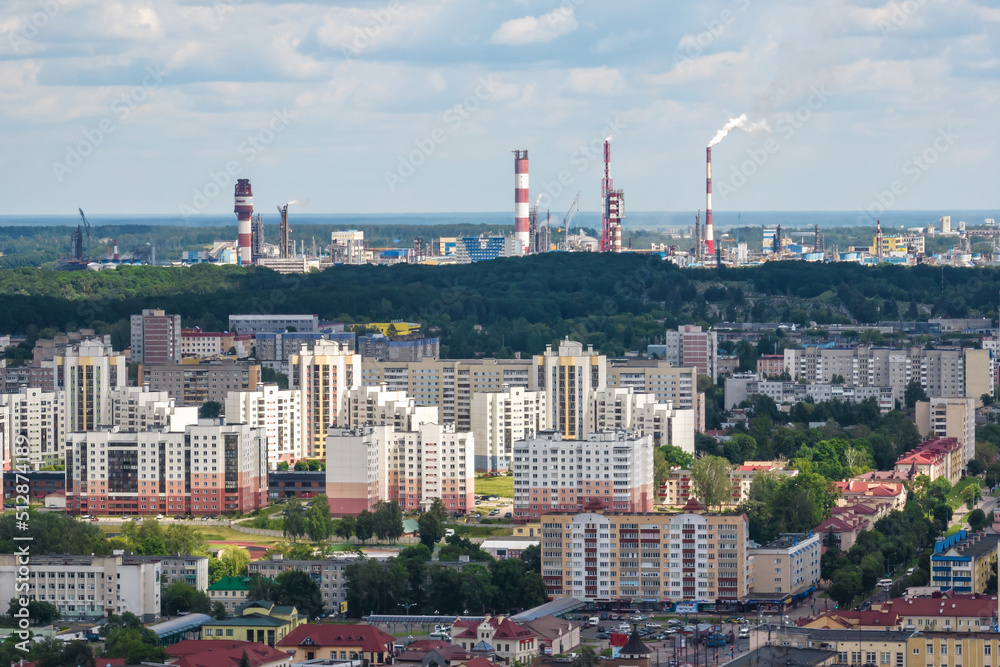 ariel panoramic view of city and skyscrapers with a huge factory with smoking chimneys in the background ariel panoramic view of city and skyscrapers with a huge factory with smoking chimneys in the background