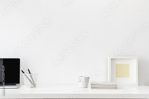 Home office, creative desk with office supplies and empty table space. White, simple interior workspace.. 