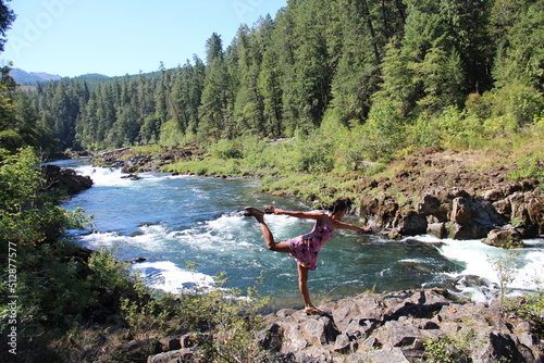 Woman stretching legs, Umpqua River, Oregon