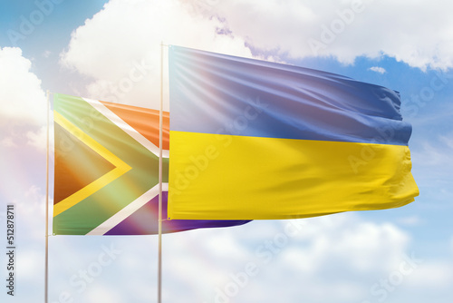 Sunny blue sky and flags of ukraine and south africa