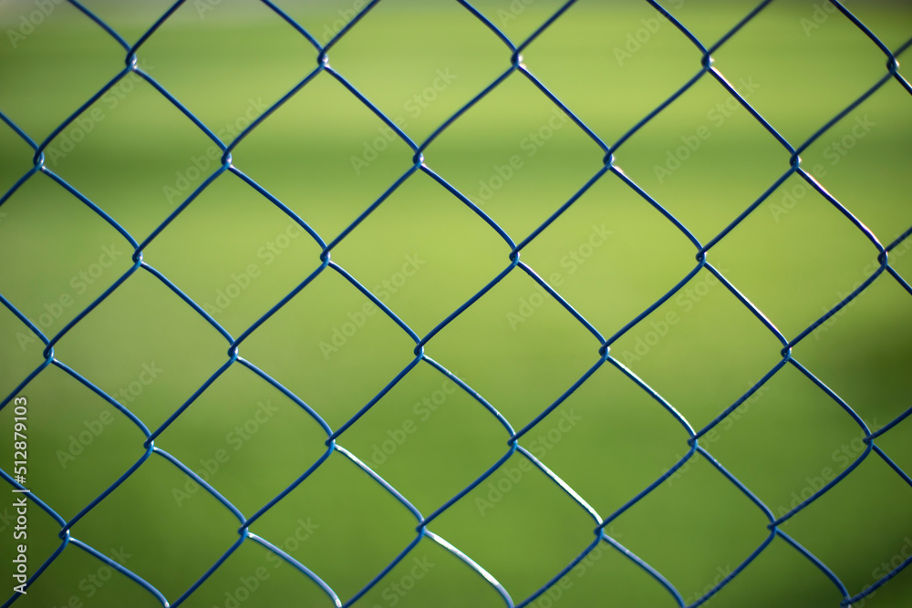 Mesh fence on vernacular background. Fence details. Mesh fence on vernacular background. Fence details.