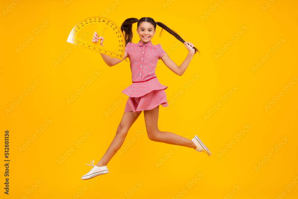 Back to school. School girl hold ruler measuring isolated on yellow background. Happy teenager, positive and smiling emotions of teen schoolgirl. Back to school. School girl hold ruler measuring isolated on yellow background. Happy teenager, positive and smiling emotions of teen schoolgirl.