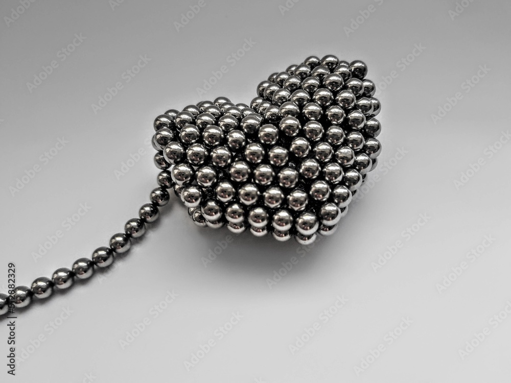Neocube magnetic balls gray color heart made on white background. Children's magnetic toy
Neocube magnetic balls gray color heart made on white background. Children's magnetic toy