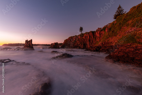 Water flowing between rock formation on the shore.