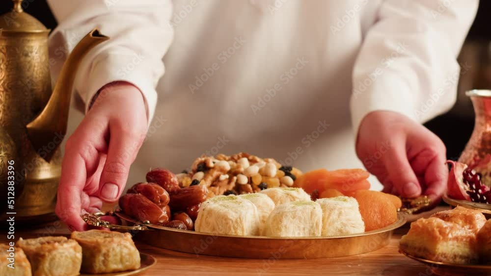 Turkish sweet food. Arabian cuisine. Baklava, nuts, pismaniye and tea close-up. Middle eastern national sugar treats, dessert snack. Turkish sweet food. Arabian cuisine. Baklava, nuts, pismaniye and tea close-up. Middle eastern national sugar treats, dessert snack.
