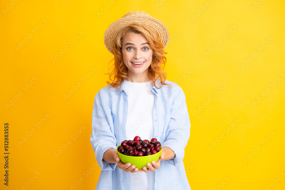 Womans enjoying a fresh sweet cherry. Female eating cherries on yellow background. Womans enjoying a fresh sweet cherry. Female eating cherries on yellow background.