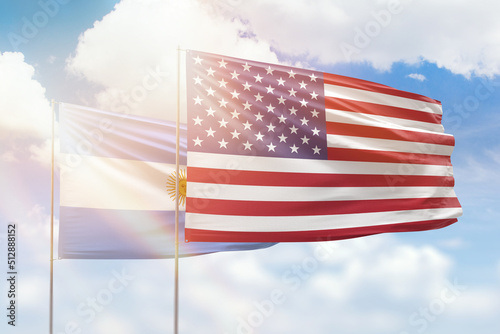 Sunny blue sky and flags of united states of america and argentina