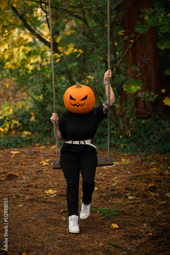 jack o lantern pumpkin on a swing