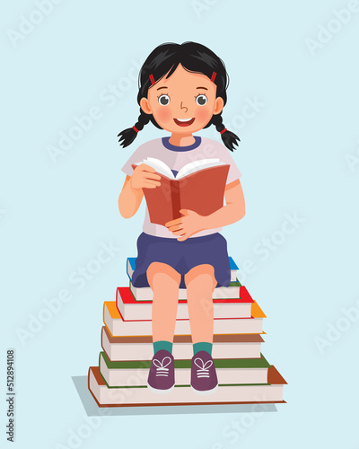 cute little girl student sitting on stack of books reading
