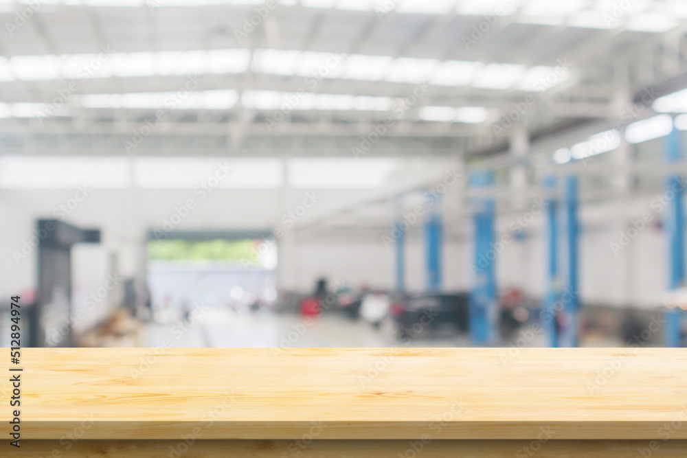 Empty wood table top with car service centre auto repair workshop blurred background Empty wood table top with car service centre auto repair workshop blurred background