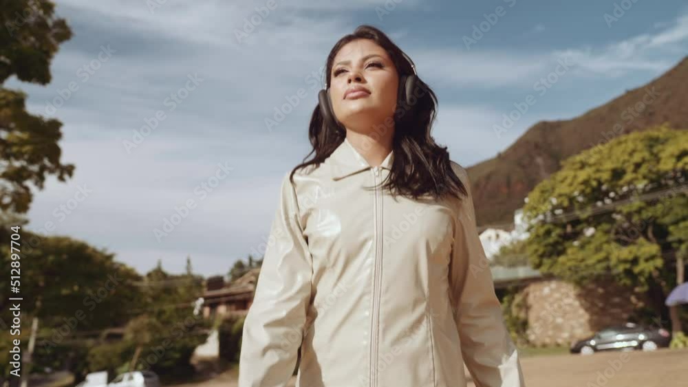 Latin woman runner running in central median of city street. Female jogger training for marathon as part of active healthy lifestyle. Slow motion young woman jogging. Cinematic 4K Latin woman runner running in central median of city street. Female jogger training for marathon as part of active healthy lifestyle. Slow motion young woman jogging. Cinematic 4K