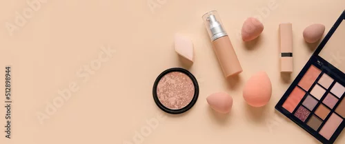 Obraz Makeup sponges and different cosmetics on beige background with space for text, top view