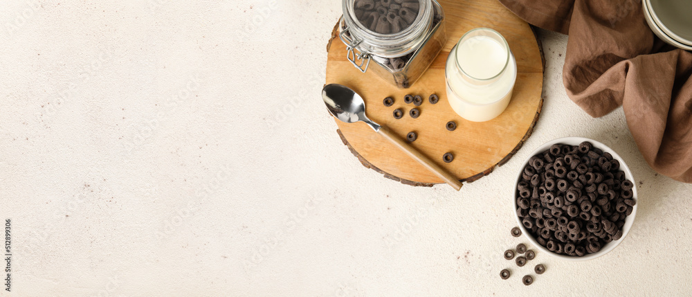 Composition with tasty cereal rings and milk on light background with space for text, top view Composition with tasty cereal rings and milk on light background with space for text, top view