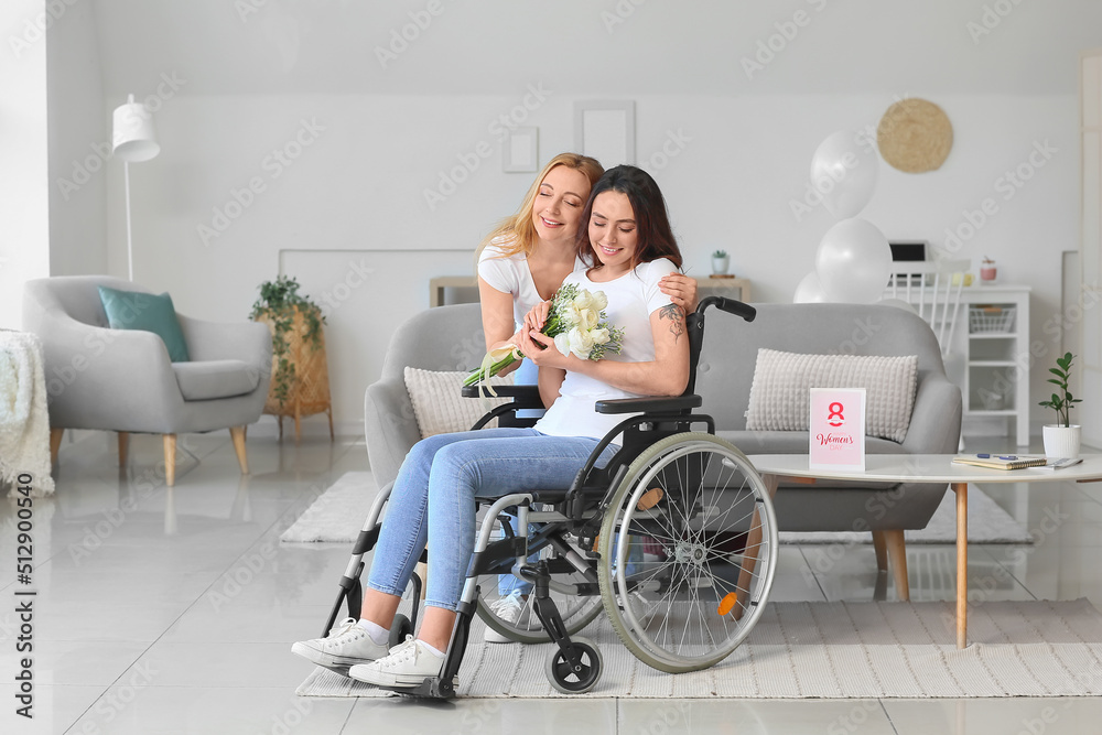 Mature woman greeting her daughter in wheelchair for International Women's Day at home