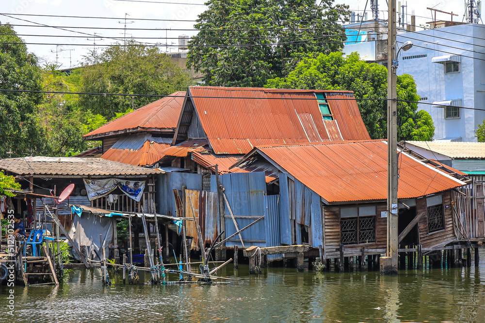 Bangkok,Thailand on May1,2020:Rural scene of old waterside houses along Khlong Bangkok Yai(Bangkok Yai Canal). Bangkok,Thailand on May1,2020:Rural scene of old waterside houses along Khlong Bangkok Yai(Bangkok Yai Canal).