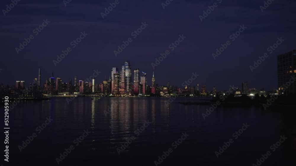 Aerial view over the river towards the illuminated Hudson yards skyline, in Manhattan, New York, USA Aerial view over the river towards the illuminated Hudson yards skyline, in Manhattan, New York, USA