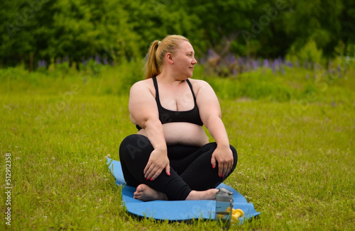 Portrait of happiness plus size woman practicing yoga on outdoors.