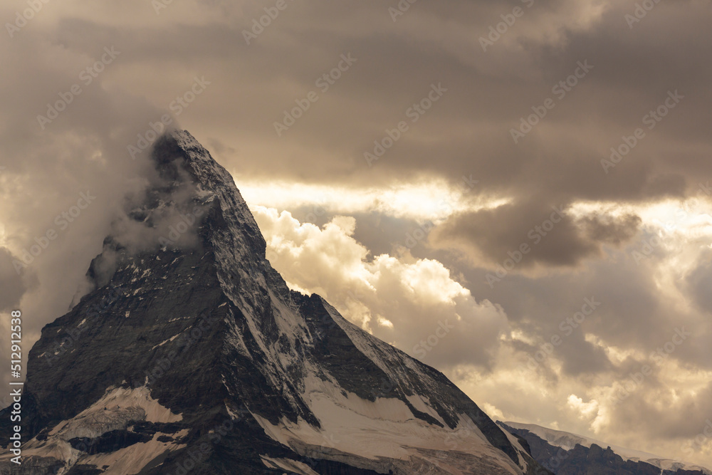 Beautiful cloudscape in the Swiss Alps in summer, with Matterhorn peak in the background Beautiful cloudscape in the Swiss Alps in summer, with Matterhorn peak in the background