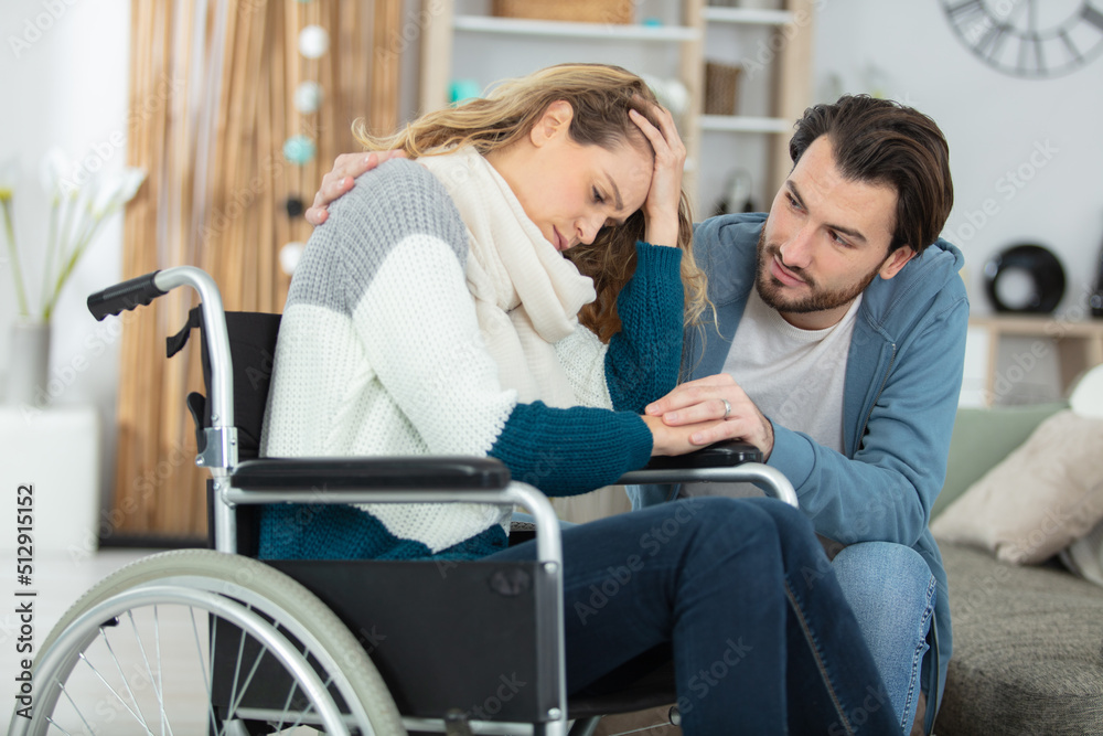 sad young woman in invalid chair and her boyfriend