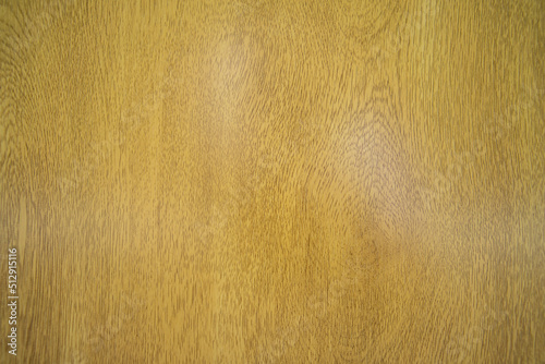 Background texture of a yellow or gold wooden table surface.