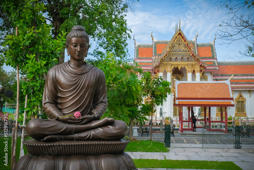 Buddha statues in various gestures at the Bodhi tree courtyard in Wat Benchamabophit. photo