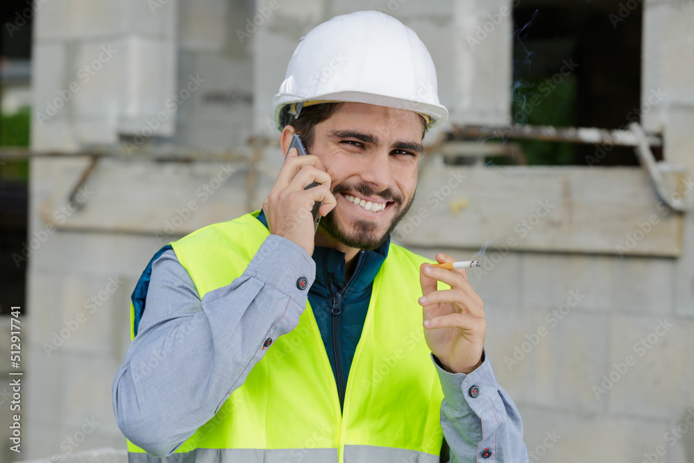 smoking worker using smart phone with factory smoking worker using smart phone with factory