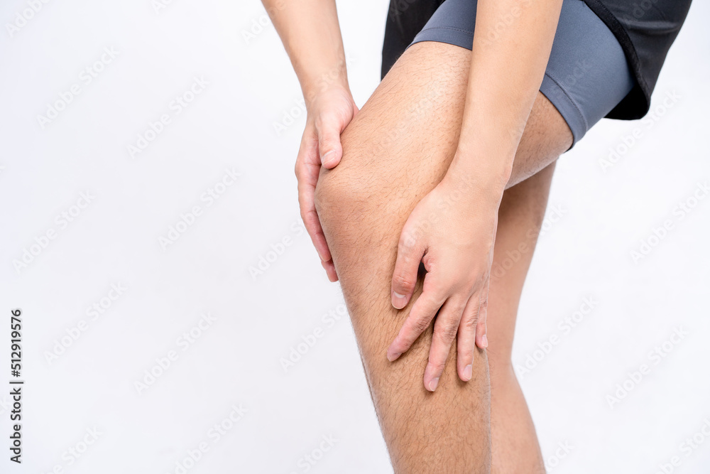Young man touching knee pain point. Health care and medical concept.