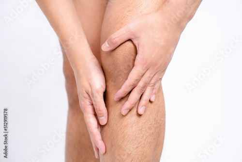 Close-up of Asian men with knee and leg pain By using hands to massage body to relieve pain, medical symptom and healthcare concept.