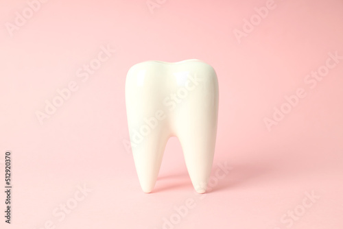 Concept of dental care  tooth on pink background