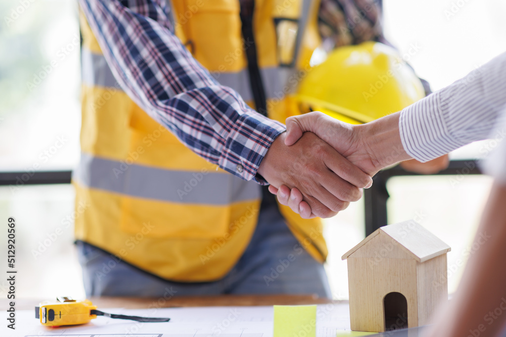 Architect contractor shaking hands with client after seal a deal to renovate building, engineer handshake partnership and contractor concept Architect contractor shaking hands with client after seal a deal to renovate building, engineer handshake partnership and contractor concept