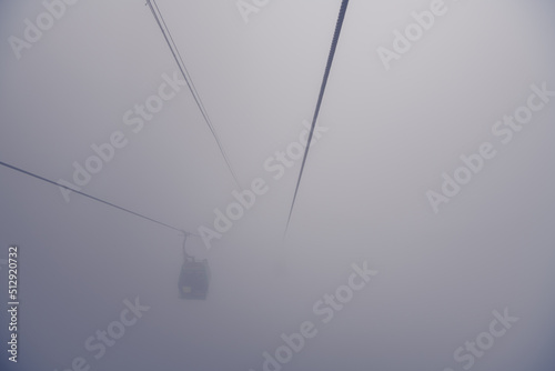 Cable car getting through the dense fog in Zhangjiajie, Hunan, China, horizontal image with copy space for text