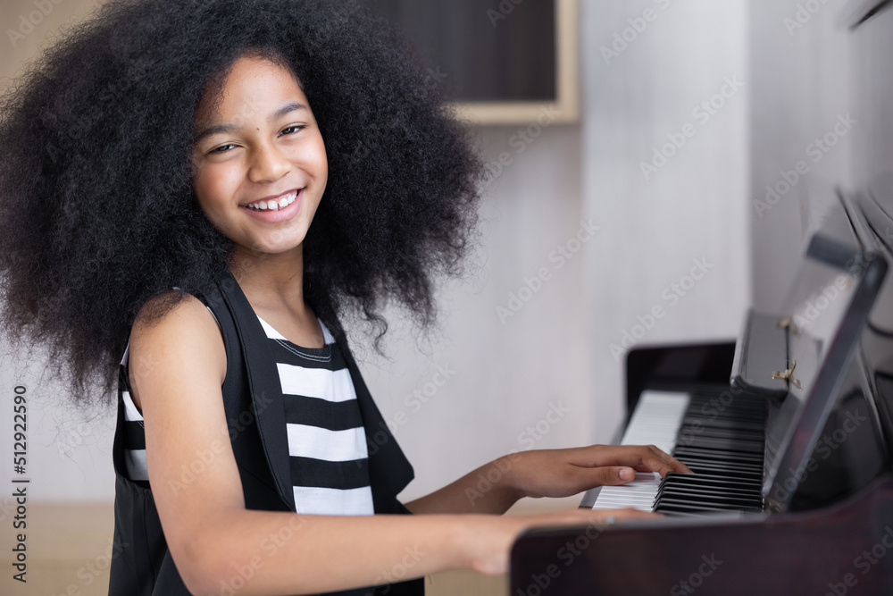 African black children playing piano music instrument happy smiling