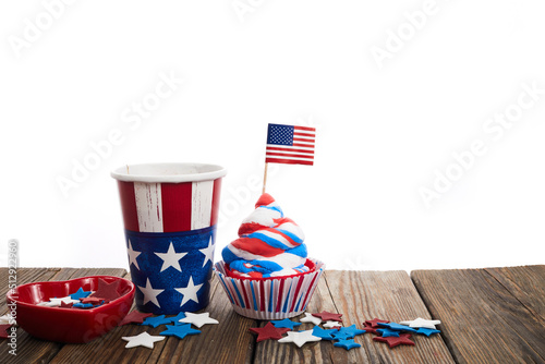 American independence day, celebration and holidays concept - cupcake in disposable tableware and stars.