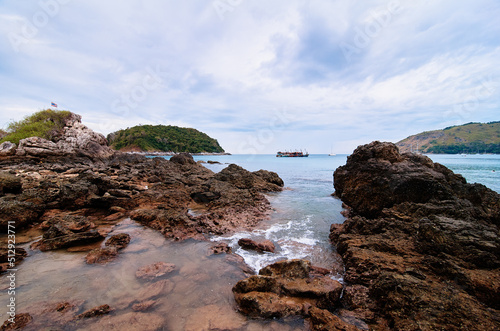 Beautiful landscape with sea, rock, stones and cloudy sky. © luengo_ua