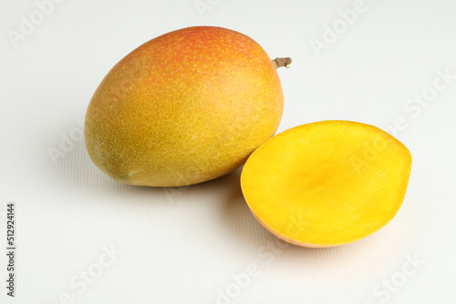Mango fruit with mango slice placed on a white background