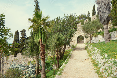 Ancient mediterranean park pathway in summer time.