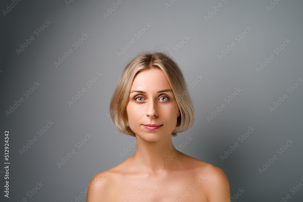 Natural beauty. Blonde woman with healthy skin. No makeup. Grey background. Natural beauty. Blonde woman with healthy skin. No makeup. Grey background.