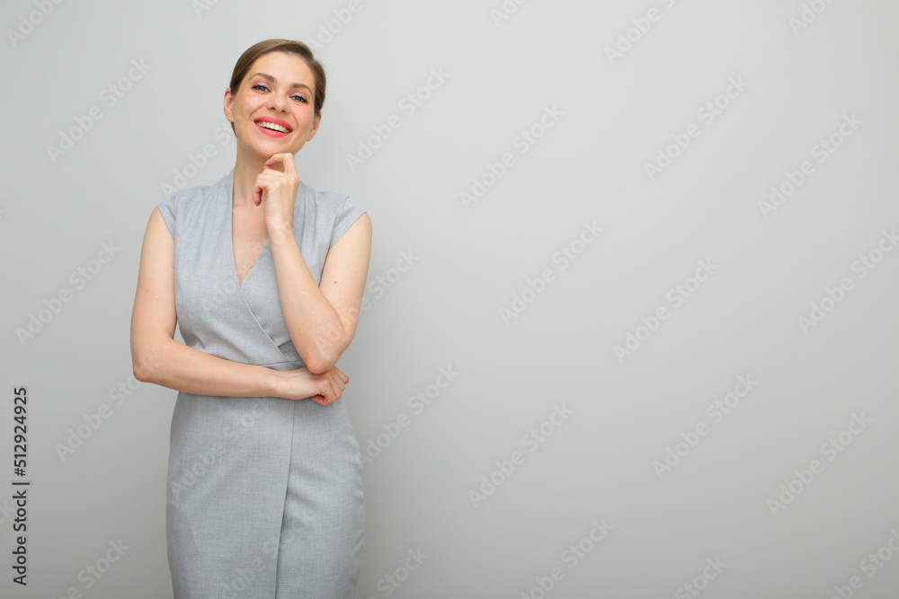 Thinking business woman with short hairstyle touching her chin isolated female studio portrait, young business lady in gray dress. Thinking business woman with short hairstyle touching her chin isolated female studio portrait, young business lady in gray dress.