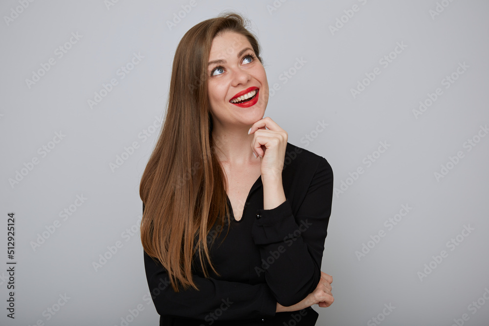 Smiling business woman in black shirt thinking and looking up, isolated portrait Smiling business woman in black shirt thinking and looking up, isolated portrait