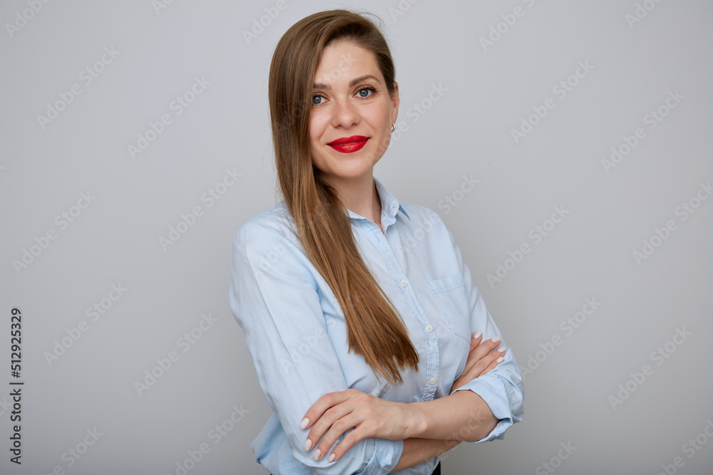 Businesswoman in blue shirt standing with arms crossed. Business woman with red lips and long hair. Businesswoman in blue shirt standing with arms crossed. Business woman with red lips and long hair.