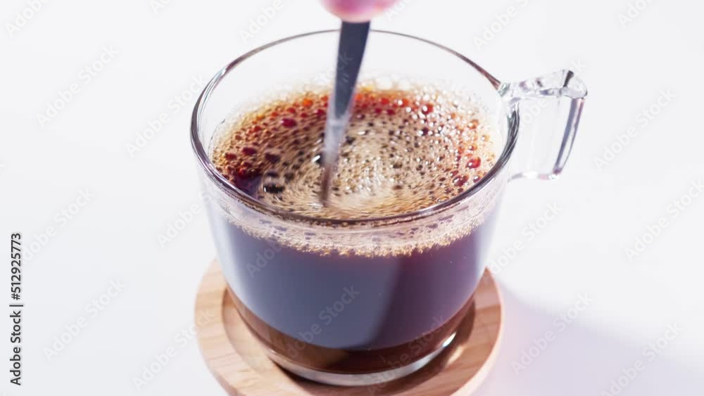Teaspoon stirring coffee in a cup Teaspoon stirring coffee in a cup