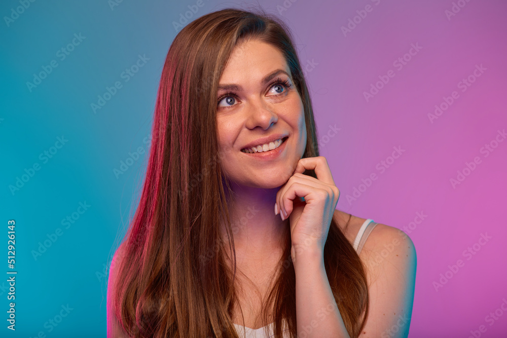 Smiling woman looking up face portrait with neon lights colors effect. Girl isolated on neon background. Smiling woman looking up face portrait with neon lights colors effect. Girl isolated on neon background.